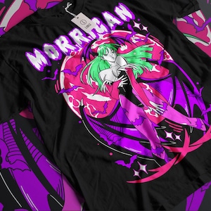 May include: Black t-shirt with a pink and purple illustration of a woman with green hair and wings. The text "MORRIGAN" is written in white letters on the shirt.