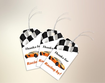 May include: Three white gift tags with black and white chequered flags and orange race cars. The tags say "Thanks for Racing by!"