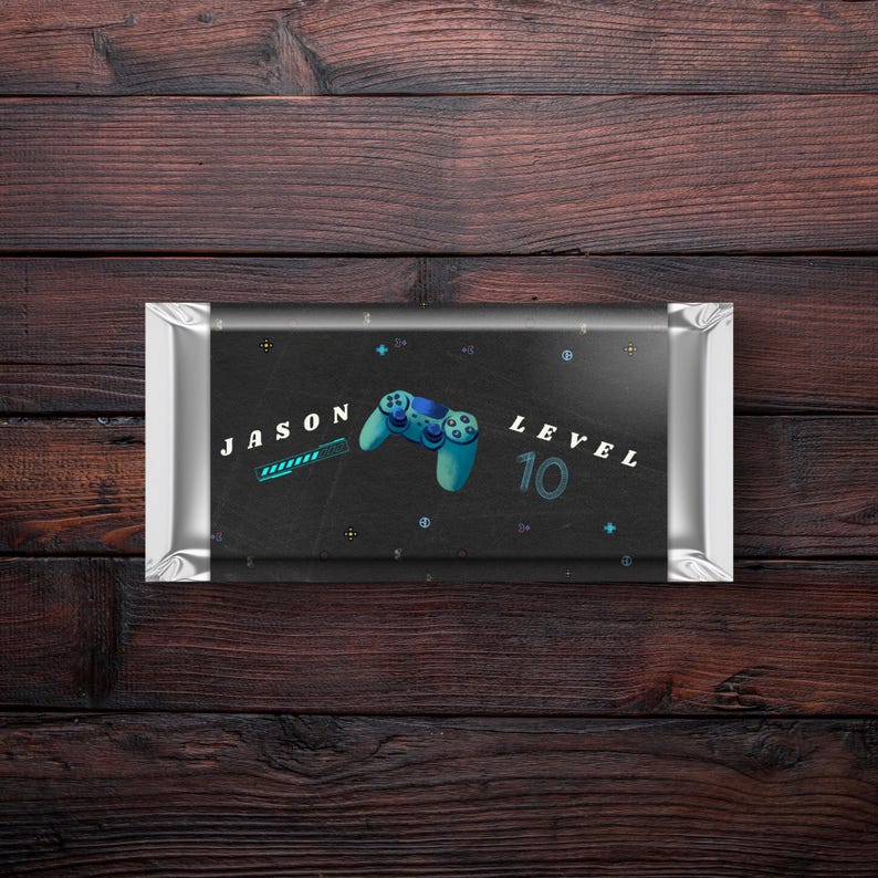 May include: A black and silver chocolate bar wrapper with a blue and green video game controller graphic. The wrapper has the text "JASON LEVEL 10" on it.