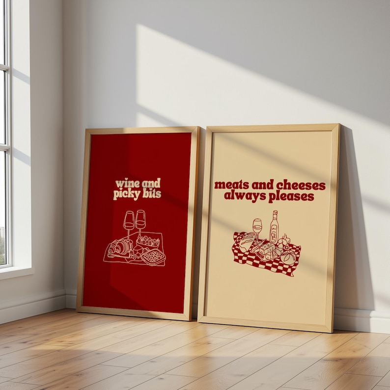 Framed retro kitchen print with bold red typography 'meats and cheeses always pleases' and a charcuterie basket illustration.