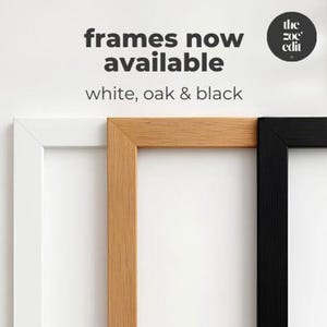 Three picture frames in white, oak wood, and black are displayed side-by-side with text stating frames now available in white, oak and black.