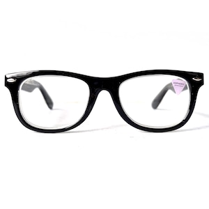 May include: Black-framed spectacles with clear lenses. The glasses have a classic, rectangular shape with a thick frame and temples. A small, purple sticker with white text is on the right lens. The spectacles are set against a white background.