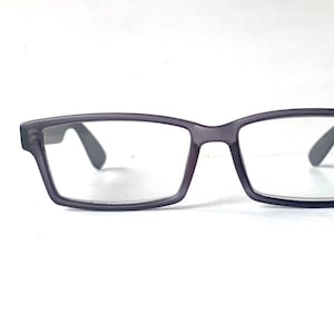 May include: Grey rectangular reading glasses with a label that says "Aspheric +1.75"