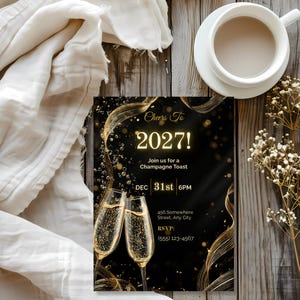 Black and gold NYE party invitation on a rustic wooden table with ivory linen and coffee