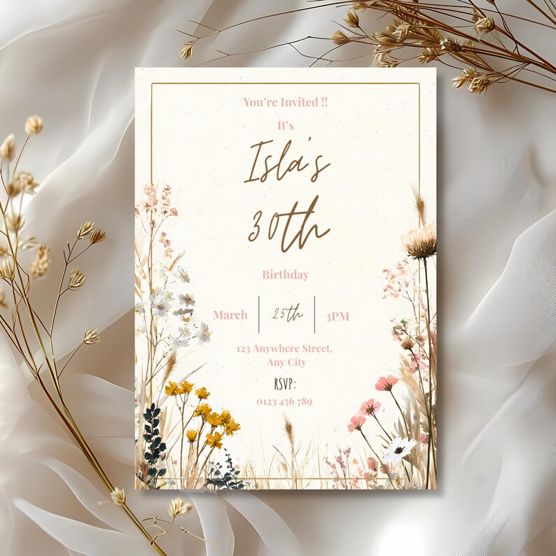 May include: A cream-colored invitation card with gold text and a gold border. The text reads "You're Invited!! It's Isla's 30th Birthday March 25th 3PM". Floral illustrations in yellow, pink, and white decorate the edges.