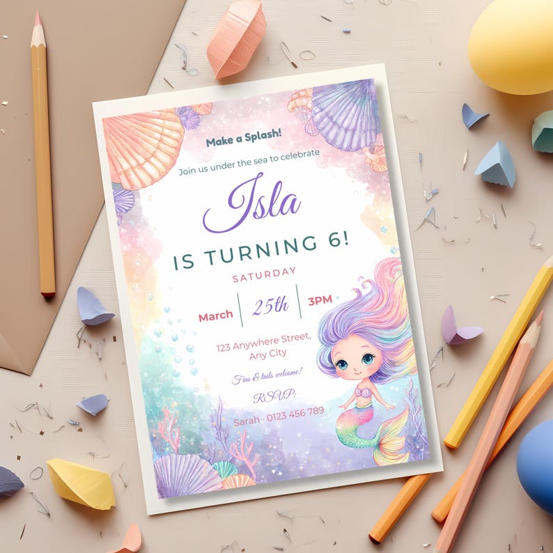 Under the sea birthday invitation flat-lay with colored pencils, paper seashells and a kraft envelope, featuring a pastel chibi mermaid.