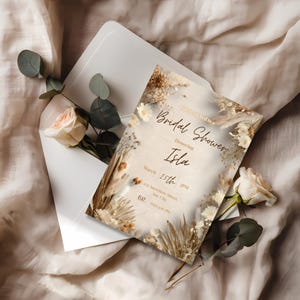 Neutral beige boho bridal shower invitation template with pampas floral elements and modern minimalist layout, editable in Canva