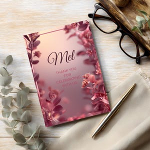 ink floral birthday invitation paired with pen and glasses, showing moody elegant