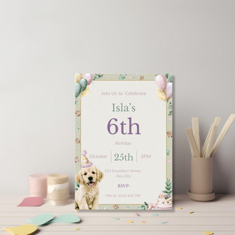 Watercolor dog birthday invitation leaning against a wall with craft thread and wooden sticks, pastel styling
