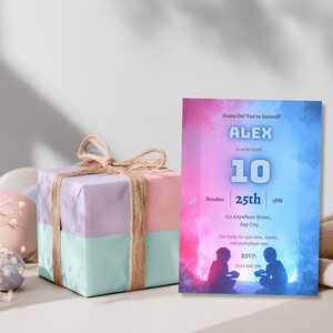 Video game birthday invitation displayed beside wrapped gift boxes, gamer party invite template for a boy's milestone birthday