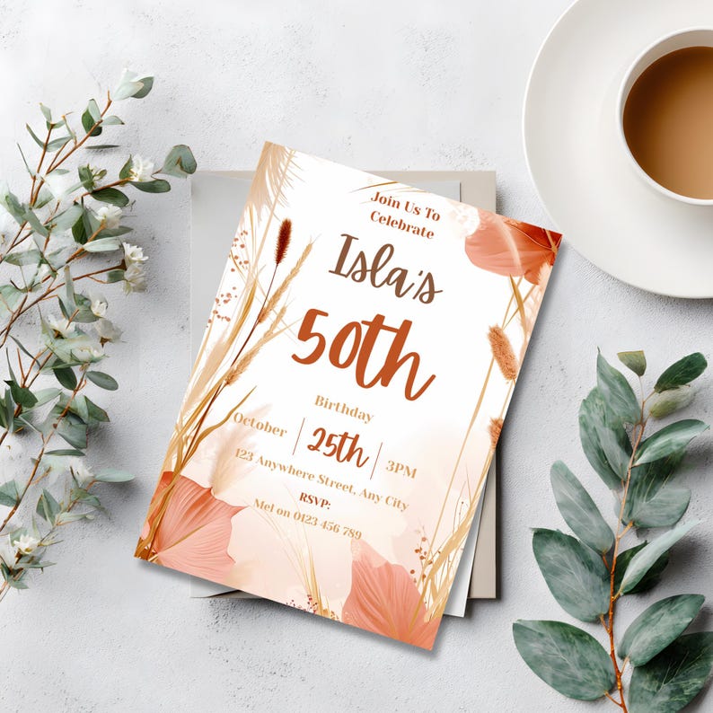 Editable boho 50th birthday invitation displayed on a table beside a cup of coffee and eucalyptus leaves