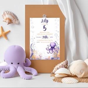 May include: A lilac octopus soft toy beside a birthday invitation. The invitation reads "Lily is turning 5" with the date October 25th, and features an octopus illustration. Seashells and a starfish are also in the image.