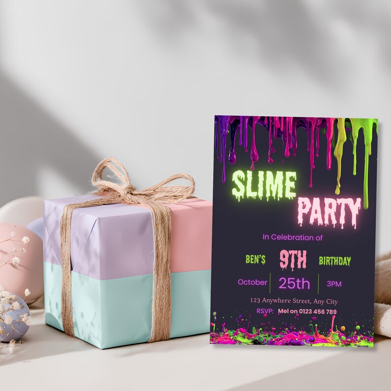 Slime birthday invitation displayed beside wrapped birthday gifts, neon pink green and purple glow design for a kids party.
