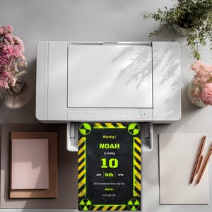 Radioactive birthday invitation design shown emerging from a printer as a clean printable invitation with warning themed typography, editable event details, and bold neon hazard styling