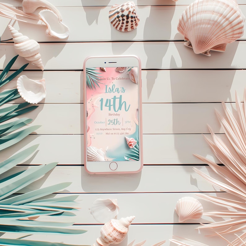 May include: A pink smartphone displays a birthday invitation with the text "Isla's 14th Birthday". The phone is surrounded by seashells and palm fronds on a white wooden surface, creating a beachy theme.