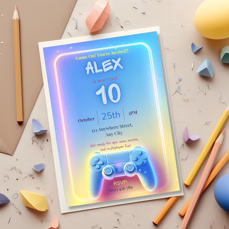 Printed arcade birthday invitation on desk with colored pencils, envelope, and craft supplies