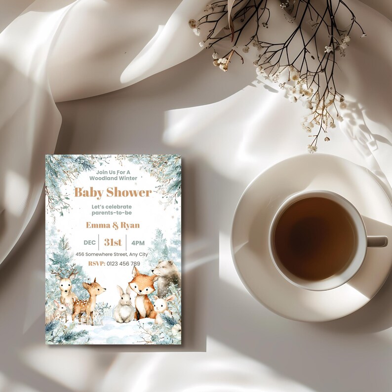 Winter woodland baby shower invitation card styled with a cup of tea and dried flowers