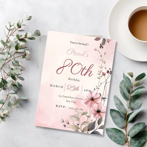 Printed 80th birthday invitation card styled with eucalyptus and coffee, pink watercolor floral design, editable Canva template