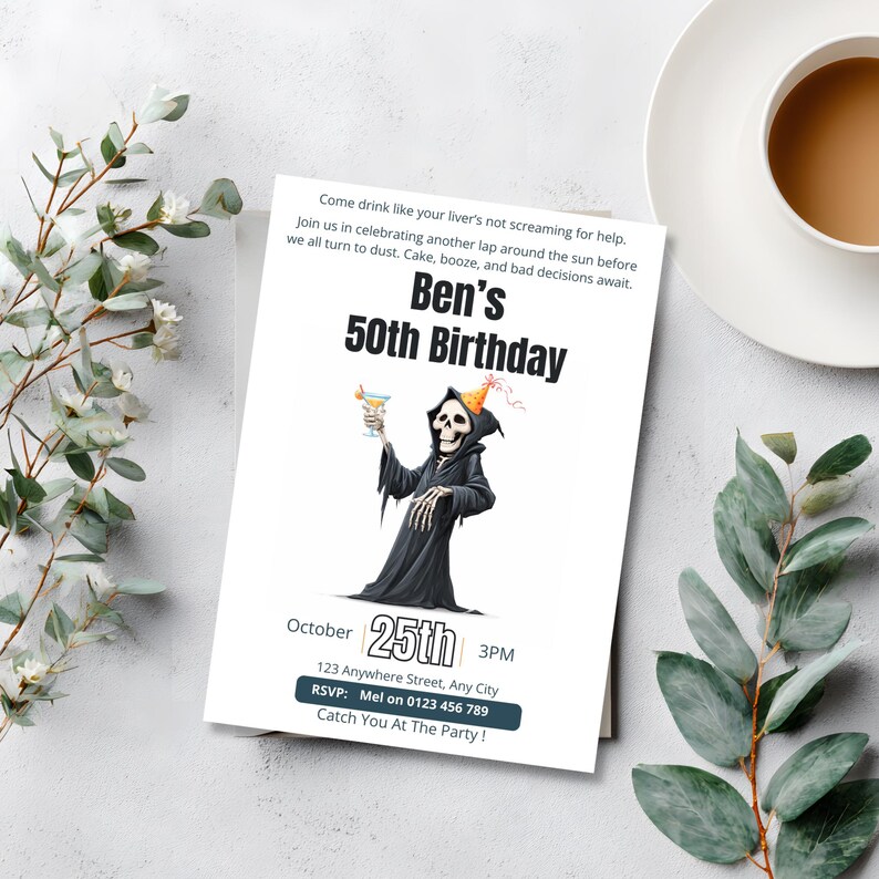 Funny Grim Reaper 50th birthday invitation styled on a marble table with coffee and eucalyptus greenery