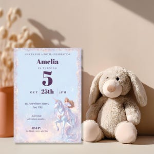 Royal celebration princess birthday invitation leaning beside a soft plush bunny toy, for a girl's 5th birthday party