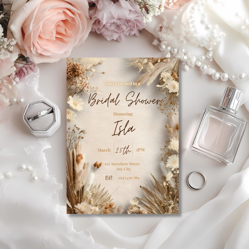 Close up of minimalist boho pampas bridal shower invitation showing neutral beige floral details and elegant typography, Canva editable