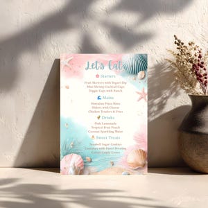 May include: A menu with a beach theme, featuring a pastel pink and blue background with seashell and starfish illustrations. The menu lists starters, mains, drinks, and sweet treats, including fruit skewers, pizza bites, pink lemonade, and seashell sugar cookies.
