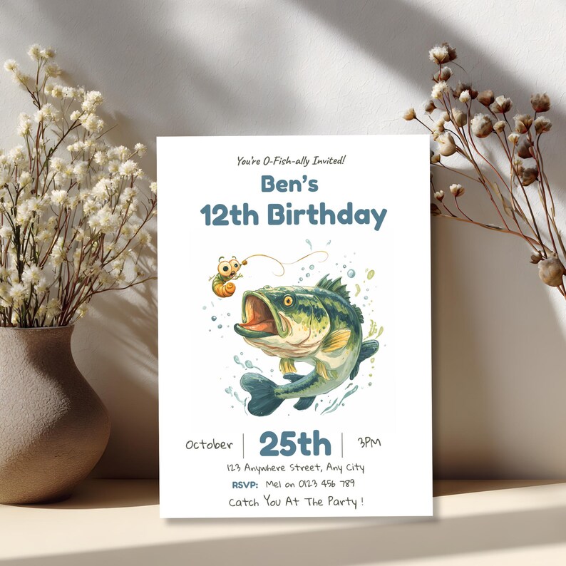 Editable fishing birthday invitation displayed beside a vase of dried flowers, showing a warm styled table setting