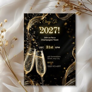 Elegant Cheers To 2027 champagne toast invitation on ivory satin with dried gold florals
