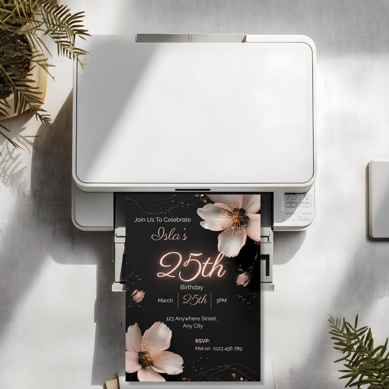 Printable black floral 25th birthday invitation template coming out of a home printer, showing how to print your editable Canva invite at home