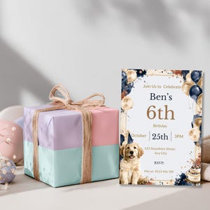 Watercolor puppy birthday invitation styled beside a wrapped pastel gift box for a boy's dog themed party