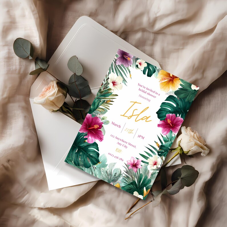Close up of tropical floral bridal shower invitation showing watercolor hibiscus blooms and lush green monstera leaves