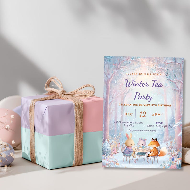 Printed girl winter tea party birthday invitation beside a pastel pink, lilac and mint gift box, woodland animal tea party invite for a 5th birthday