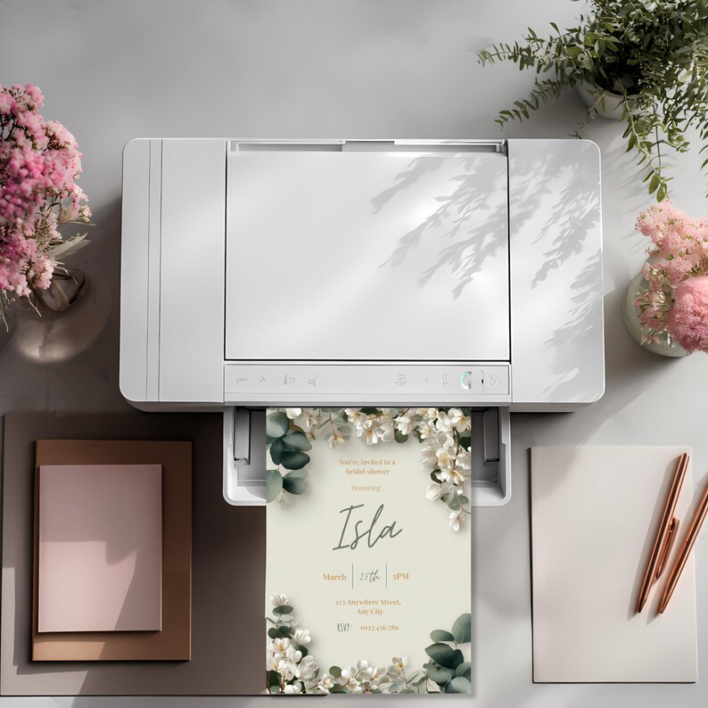 Printable bridal shower invitation coming out of printer, elegant white floral invitation template