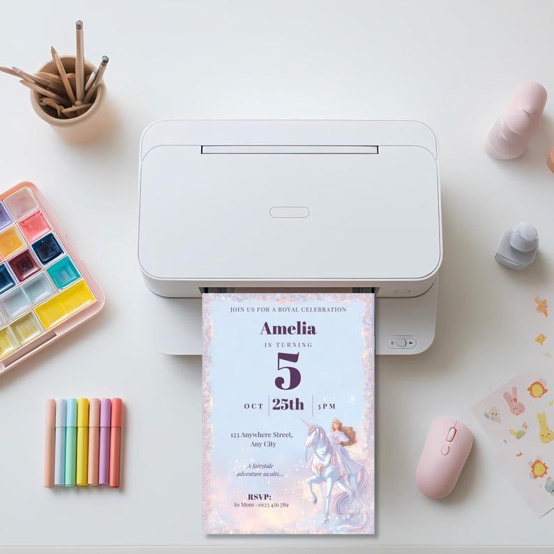 Princess birthday invitation printing from a white home printer on a desk with pastel markers and a paint palette