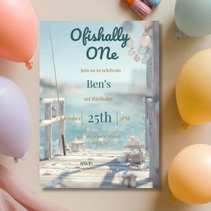 Close-up view of “Ofishally One” birthday invitation text and fishing-themed coastal design elements with soft nautical colour palette.