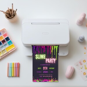 Slime birthday invitation printing from a home printer, showing the printable 5x7 inch editable Canva template.
