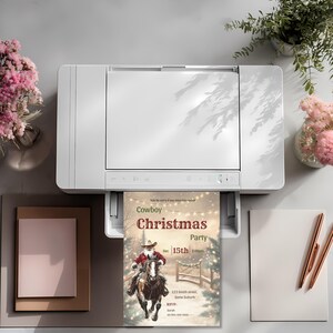 Cowboy Christmas Invitation printing from a home printer, showing how easily this editable Canva template can be printed for a western Christmas party.