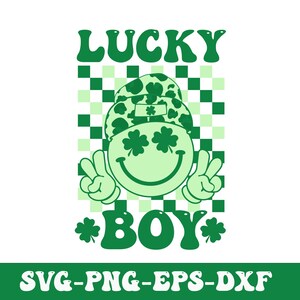 May include: Green and white graphic design with a smiling face wearing a shamrock patterned hat. The text "LUCKY BOY" is in green letters with shamrocks on either side. The background is a checkered pattern.