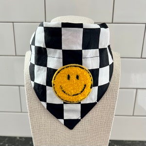 May include: Black and white checkered bandana with a yellow smiley face patch.