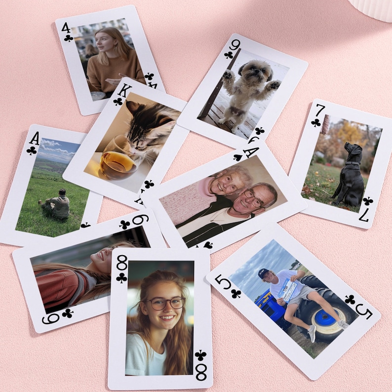 May include: A set of playing cards with photos of people and animals. The cards are arranged in a circle on a pink surface. The cards are numbered 4, 7, 9, K, A, 6, 5, and 8.