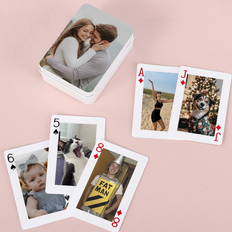 May include: A set of playing cards with custom photos printed on each card. The cards feature a variety of images, including a couple, a woman in a dress, a dog, a cat, and a man in a yellow construction vest. The cards are printed on white card stock with red and black ink.
