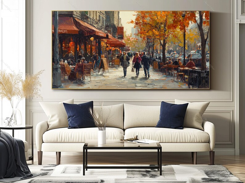 May include: A painting of a Parisian street scene with people walking and sitting at outdoor cafes. The buildings are painted in warm tones, and the trees are in autumn colors. The painting has a warm and inviting feel.