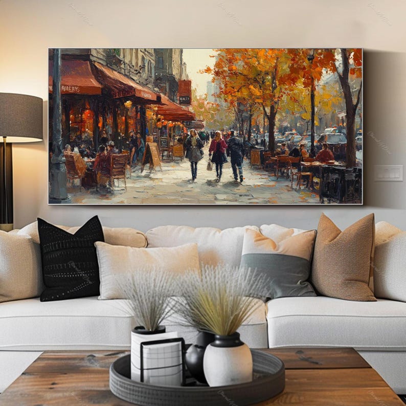 May include: A painting of a Parisian street scene with people walking past a cafe with red awnings. The trees are in autumn colors, and the street is wet from rain.