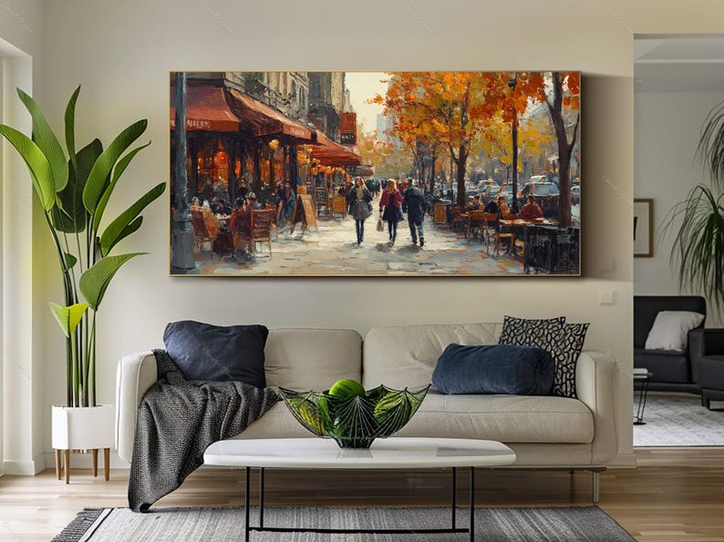 May include: A painting of a Parisian street scene with people walking and sitting at outdoor cafes. The painting features a cafe with a red awning and the word "Boulangerie" on the sign. The trees in the background are painted in shades of yellow and orange.