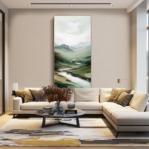 May include: An interior shot of a modern living room with a large, abstract landscape painting. The painting features green and white brushstrokes depicting a valley and river. A white sectional sofa, a patterned rug, and a marble coffee table complete the scene.