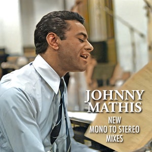 May include: A black and white photograph of Johnny Mathis singing into a microphone. The text "JOHNNY MATHIS NEW MONO TO STEREO MIXES" is superimposed on the image.