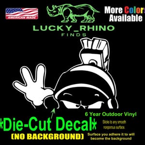 May include: Black die-cut decal featuring a cartoon character waving, with the text "LUCKY_RHINO FINDS" and "AMERICAN MADE". The decal is made of 6-year outdoor vinyl and sticks to smooth, nonporous surfaces. More colors are available.
