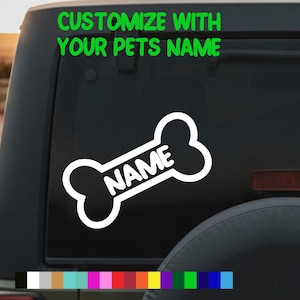 May include: A white bone-shaped sticker with the word "NAME" in a black rectangle. The sticker is on a black surface, with the green text "CUSTOMIZE WITH YOUR PETS NAME" above it. A colour palette is shown at the bottom.