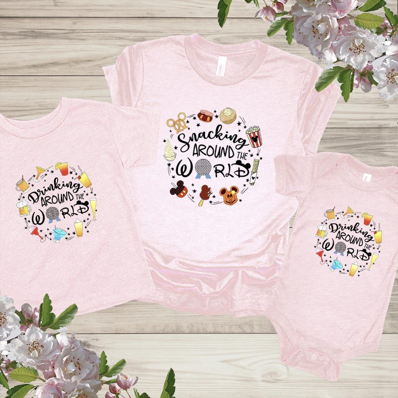 May include: Three pink t-shirts with a Disney theme. The largest shirt says "Snacking Around the World" with a Mickey Mouse head and other Disney icons. The two smaller shirts say "Drinking Around the World" with a Mickey Mouse head and other Disney icons.