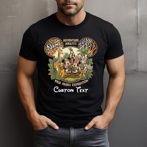 May include: Black t-shirt featuring a Disney-themed design. The design includes Mickey Mouse, Minnie Mouse, Donald Duck, and other characters in safari attire. Text includes "Adventure Awaits!" and "Wild Parks Expedition". The shirt has a customizable name and text area.